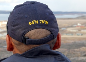 Police officer surveys the hamlet of
Cape Dorset on Baffin Island, his cap
revealing its geographic location